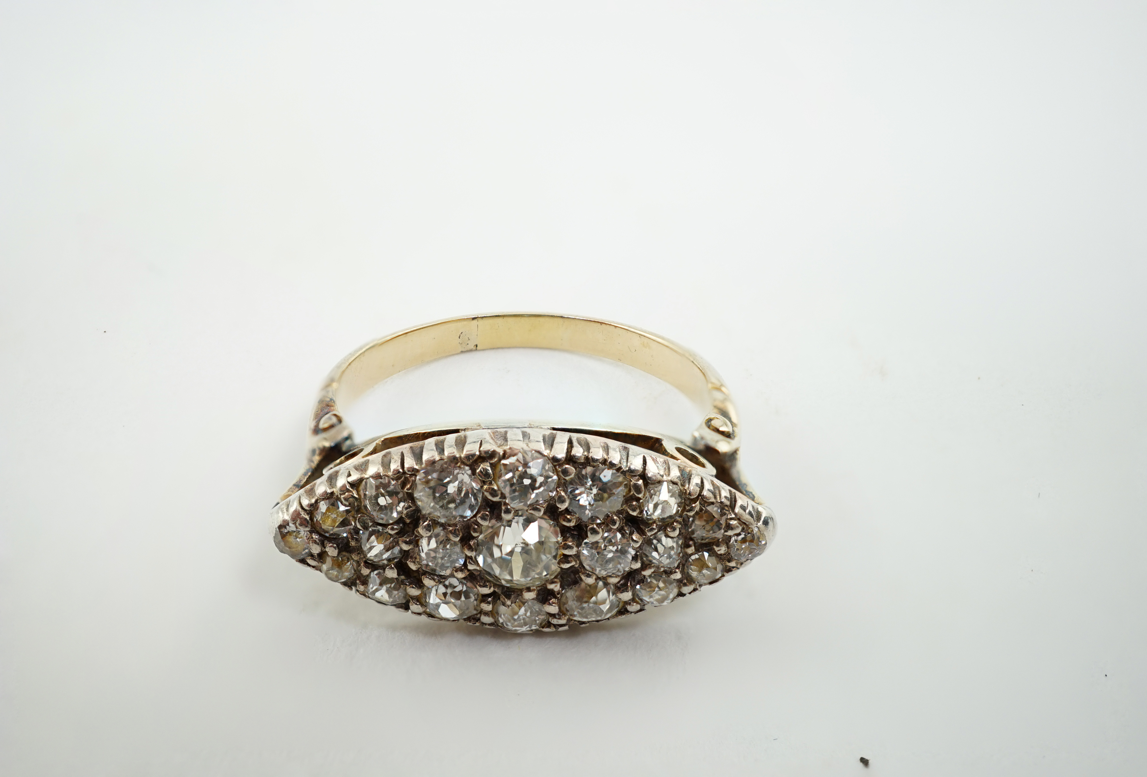 An early 20th century gold and diamond cluster set navette shaped ring